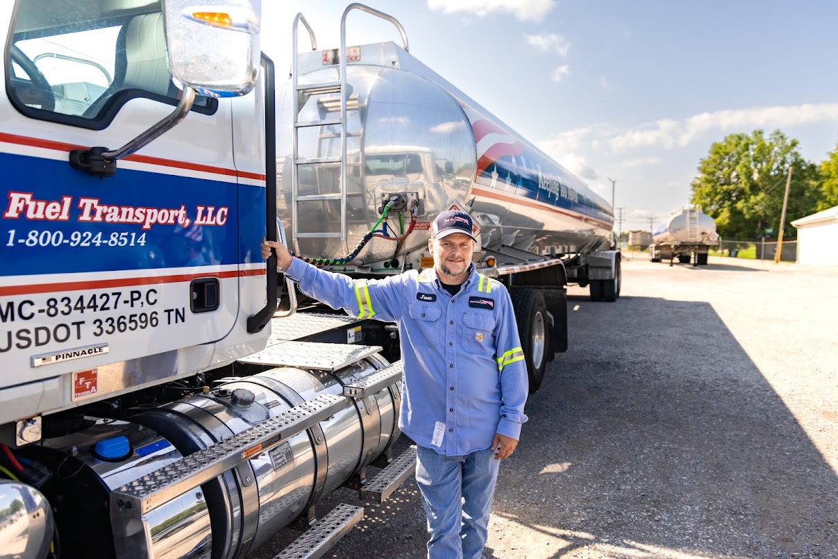 a service attendant leaning on his truck